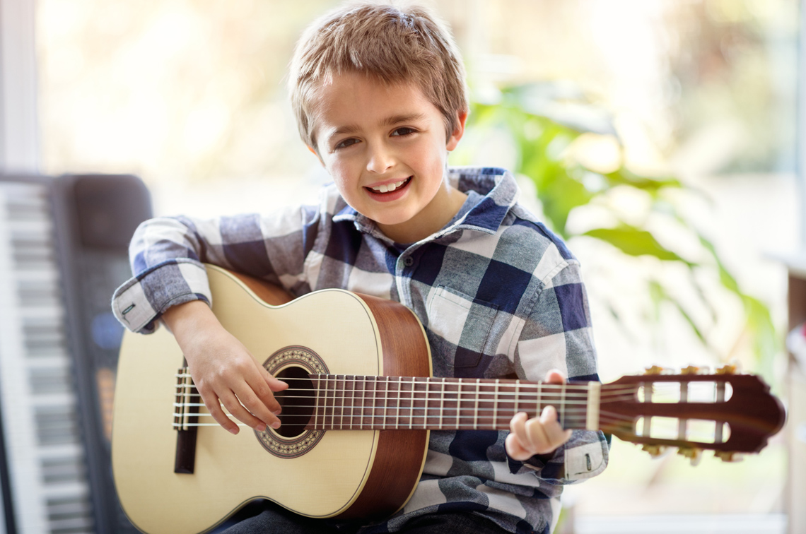 A child playing a guitar.