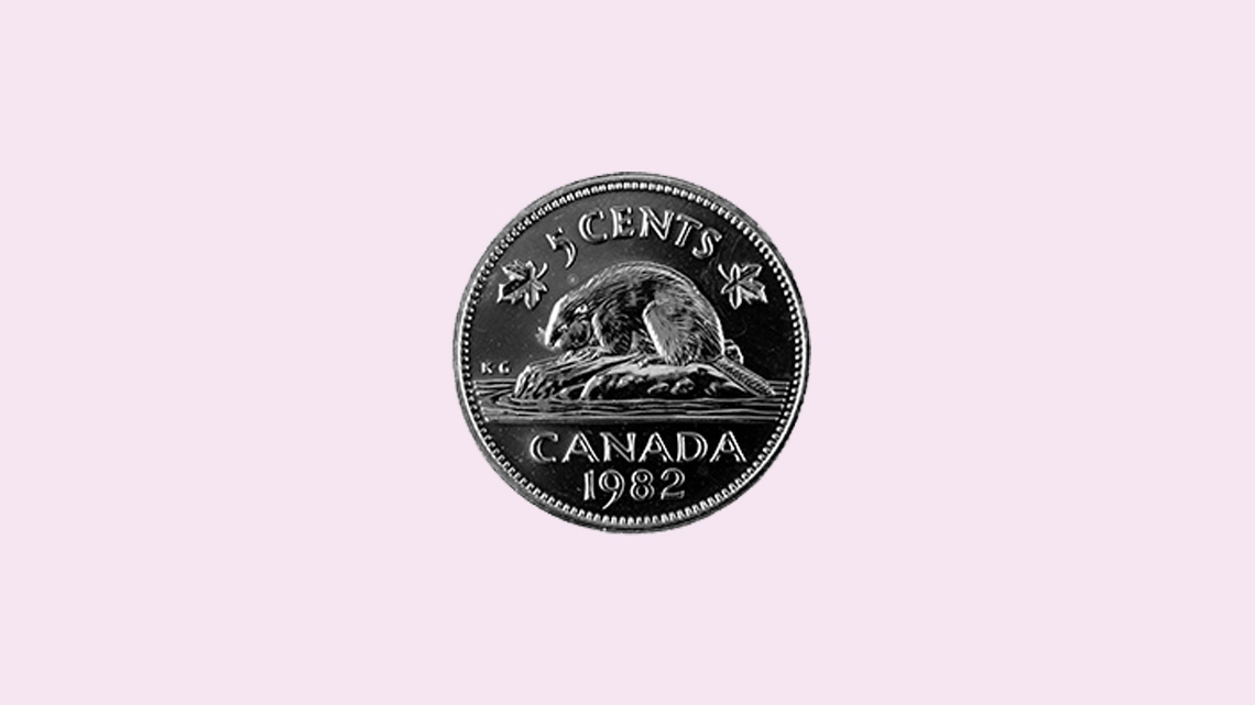 A silver, round coin with a&nbsp;beaver sitting on a&nbsp;rock. This is a&nbsp;five&nbsp;cent coin.